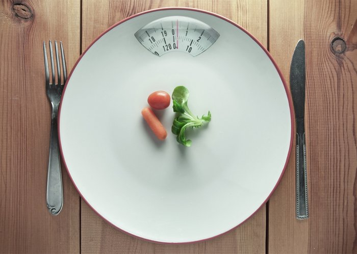 A nearly empty plate with a scale. 